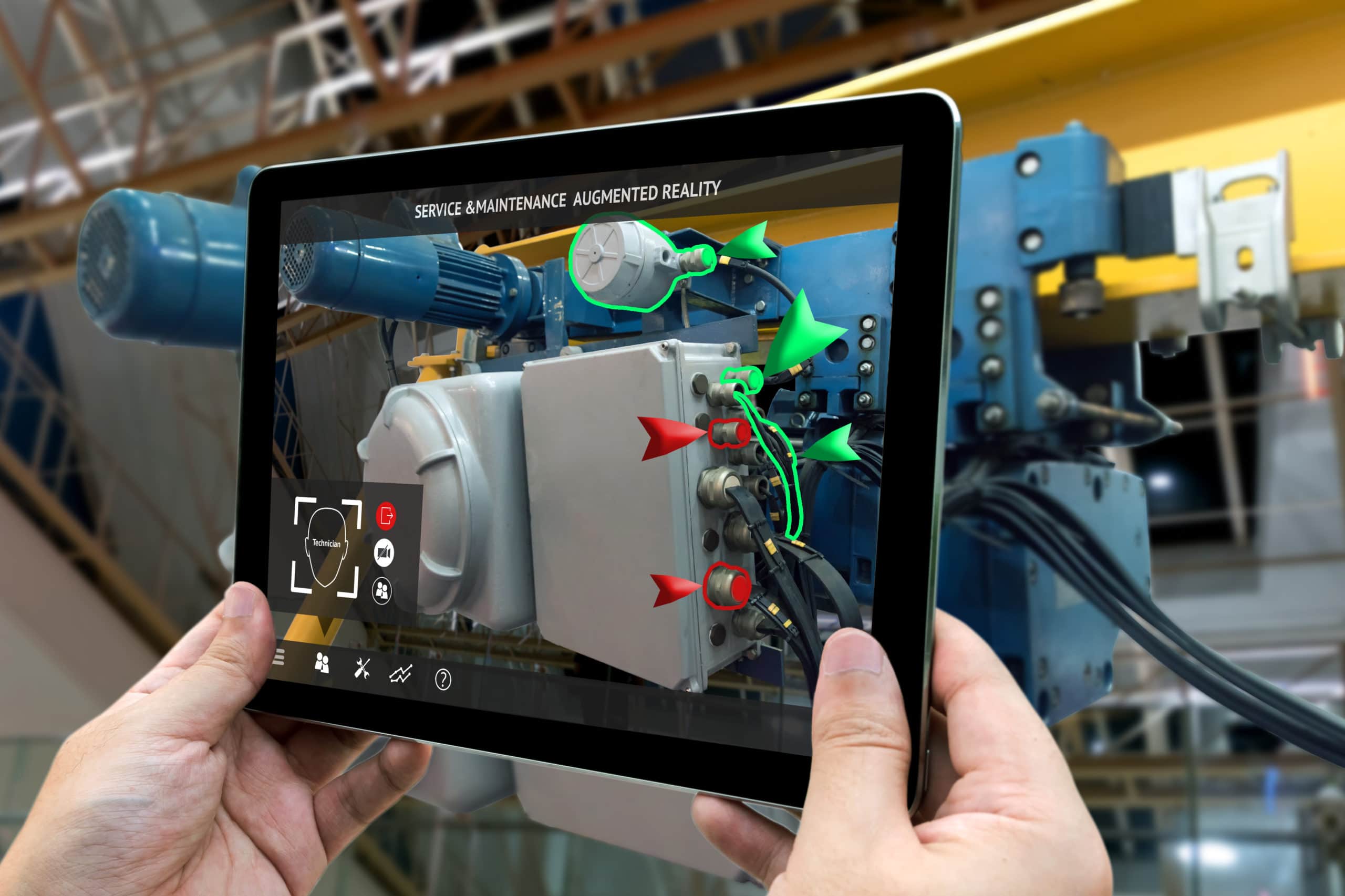 Manufacturing employee using an augmented reality app on his tablet