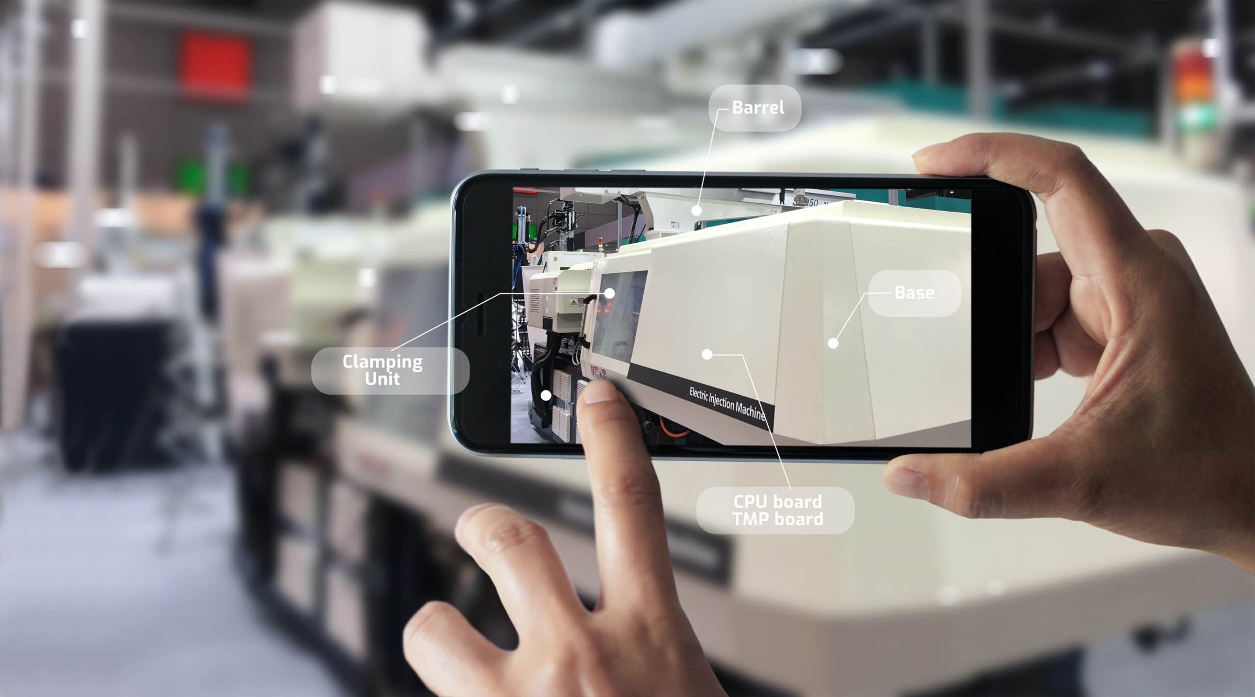 manufacturer using augmented reality app on his phone to identify parts of a machine